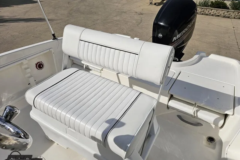 Slide: The Image of 2016 Bayliner Element F18 boat with white cushioned seating and Mercury outboard motor. - 86
