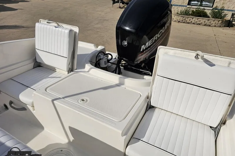 Slide: The Image of 2016 Bayliner Element F18 boat interior with Mercury outboard motor and white seating. - 88