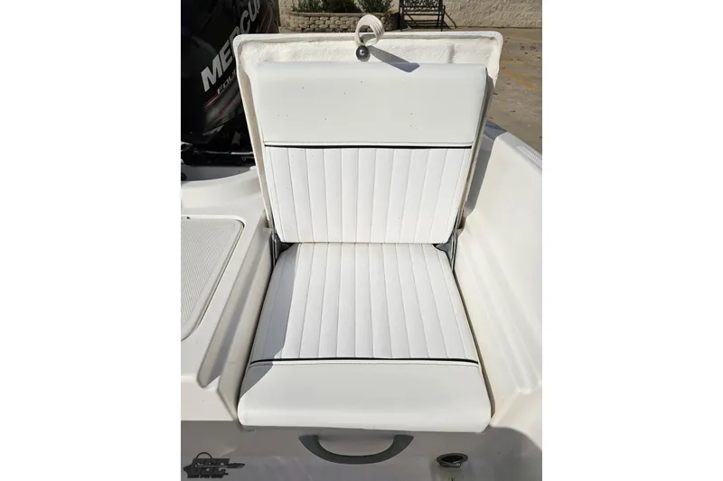Slide: The Image of 2016 Bayliner Element F18 boat seat with white cushioned upholstery. - 89
