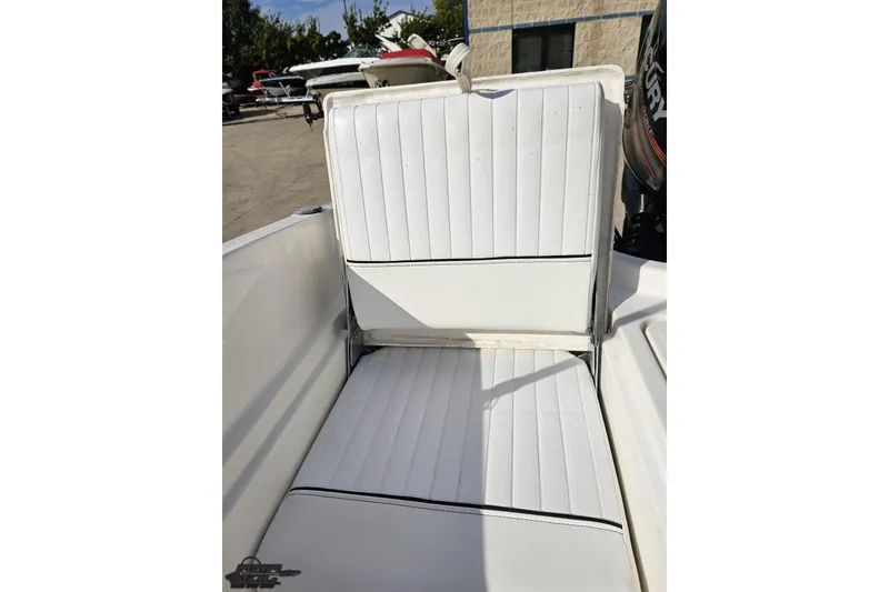 Slide: The Image of 2016 Bayliner Element F18 boat with white cushioned seating in outdoor setting. - 91