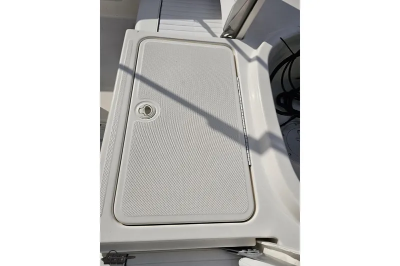 Slide: The Image of 2016 Bayliner Element F18 boat deck with storage compartment. - 94