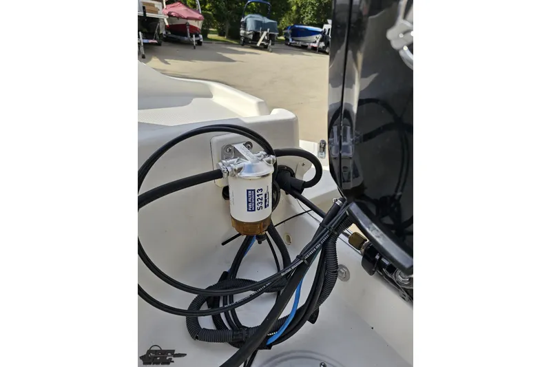 Slide: The Image of 2016 Bayliner Element F18 boat engine compartment with visible fuel filter and wiring. - 97