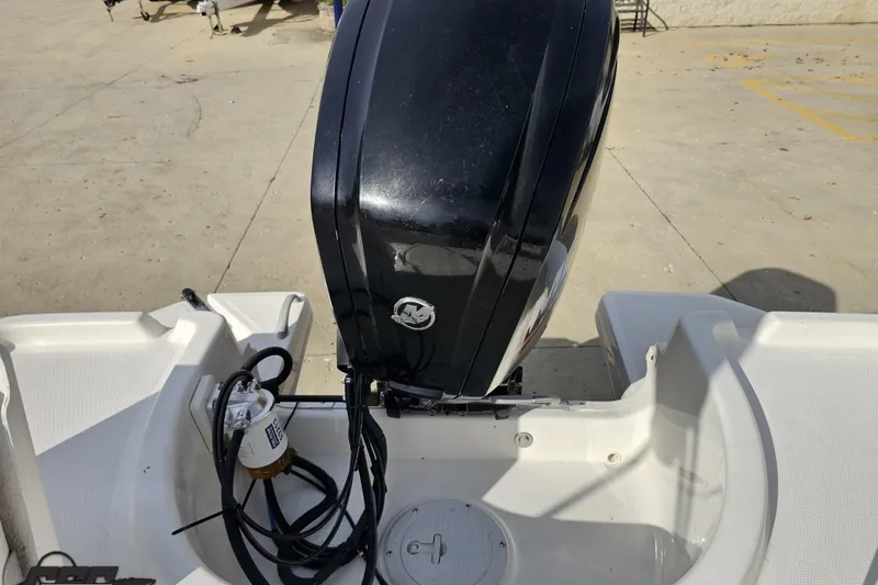 Slide: The Image of 2016 Bayliner Element F18 boat with outboard motor, viewed from the rear. - 98
