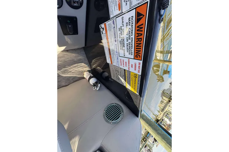 Slide: The Image of 2021 Bennington 27RX boat interior with warning labels and control panel. - 19