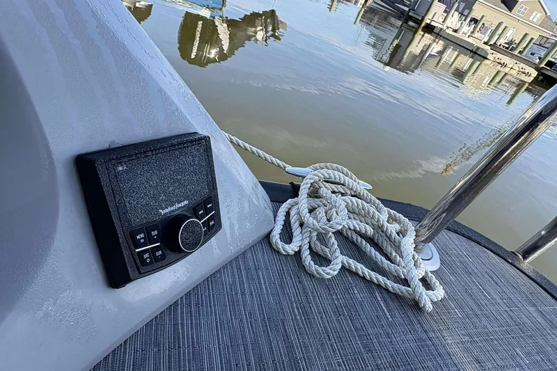 Slide: The Image of 2021 Bennington 27RX boat with audio controls and coiled rope on deck. - 20