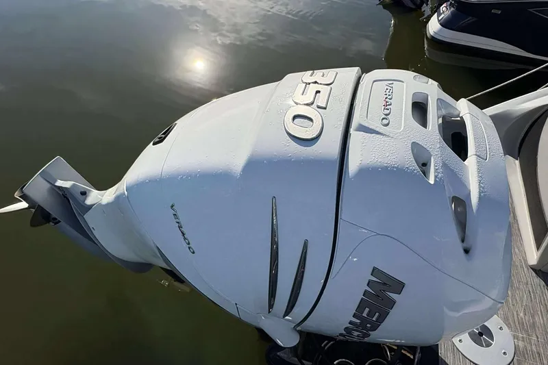 Slide: The Image of Mercury Verado 350 outboard engine on a 2021 Bennington 27RX boat, reflecting sunlight on water. - 22