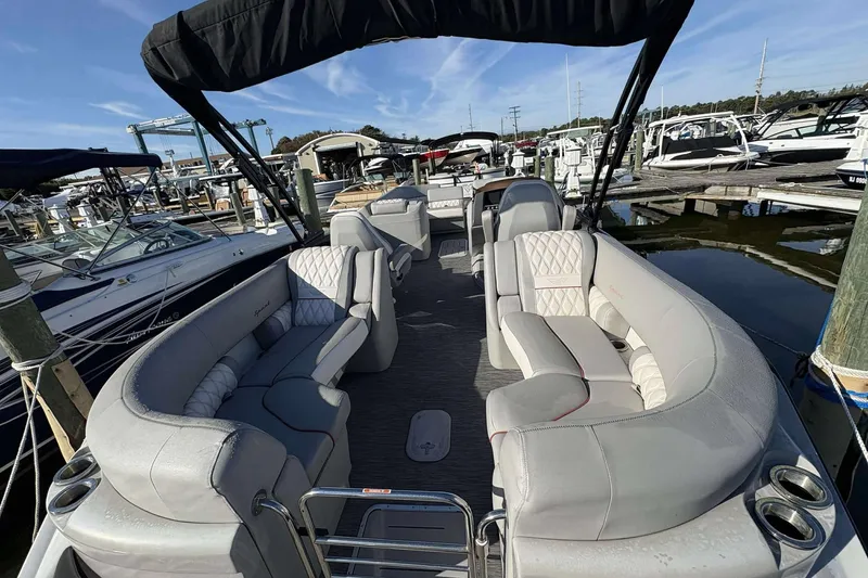 Slide: The Image of 2021 Bennington 27RX pontoon boat with luxurious seating at a marina. - 4