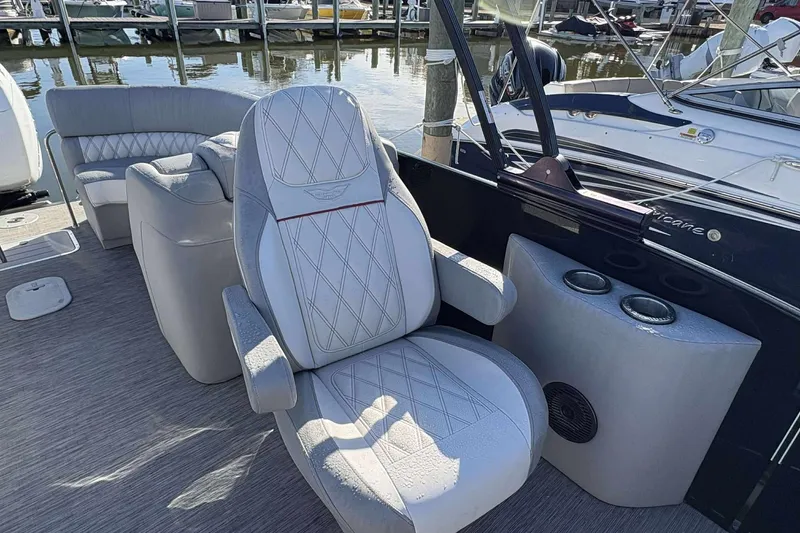 Slide: The Image of Luxurious seating on a 2021 Bennington 27RX boat, docked at a marina. - 8