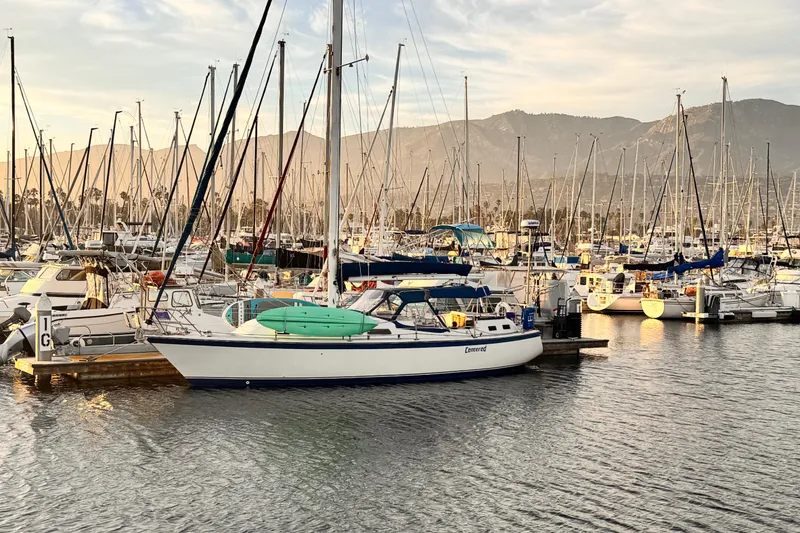 Slide: The Image of 1979 O'Day 37 Center Cockpit sailboat docked in a marina at sunset. - 1