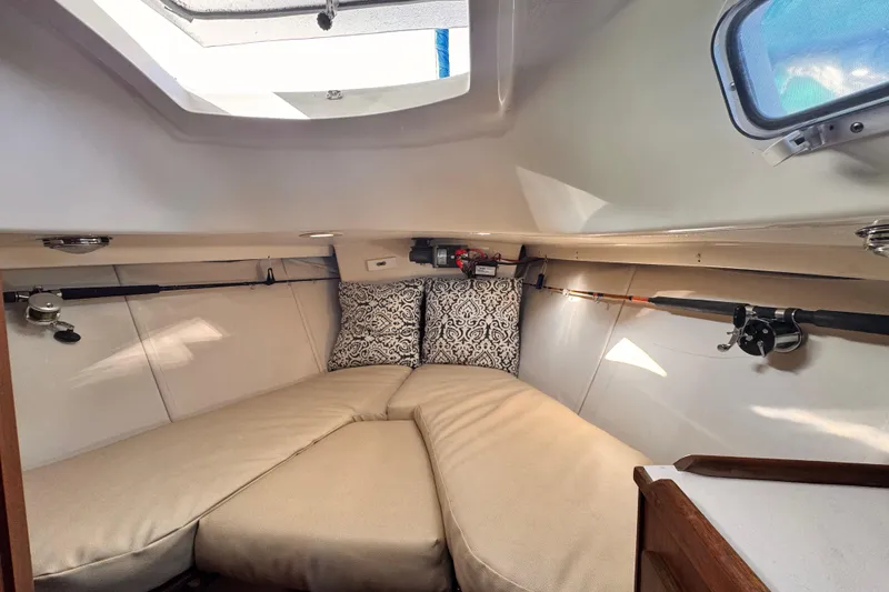 Slide: The Image of 1979 O'Day 37 Center Cockpit interior with cozy V-berth and fishing rods. - 10