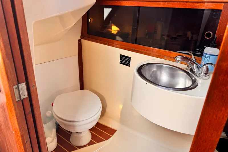 Slide: The Image of 1979 O'Day 37 Center Cockpit bathroom with toilet and sink. - 15