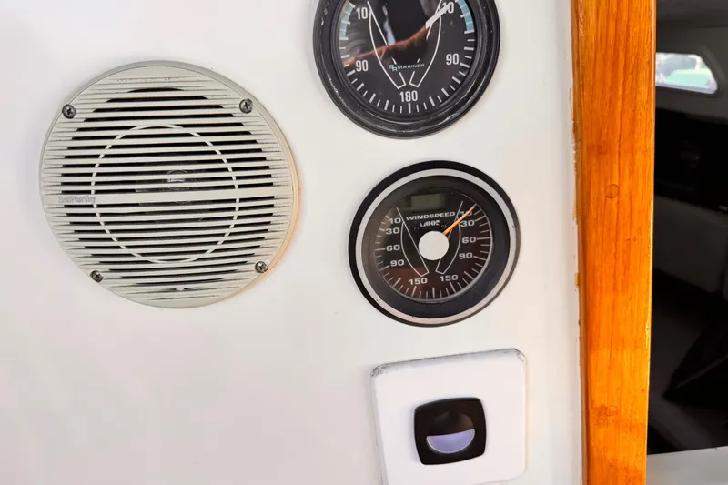 Slide: The Image of Instrument panel on a 1979 O'Day 37 Center Cockpit sailboat, featuring gauges and speaker. - 23