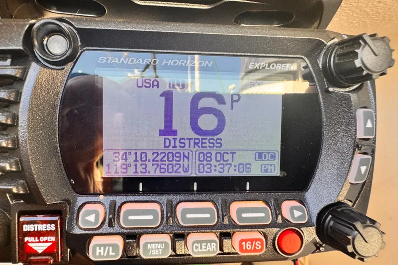 Slide: The Image of Standard Horizon Explorer marine radio displaying distress signal coordinates. - 26