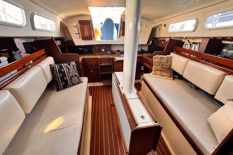Slide: The Image of Interior of 1979 O'Day 37 Center Cockpit sailboat with cozy seating and wooden accents. - 3