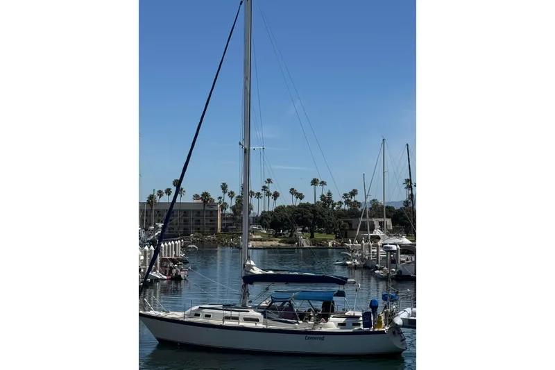 Slide: The Image of 1979 O'Day 37 Center Cockpit sailboat docked in a sunny marina. - 37