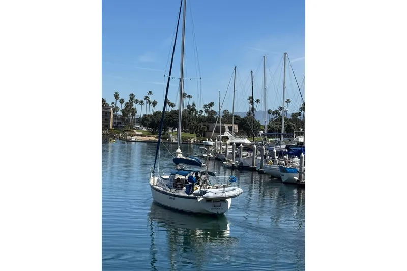 Slide: The Image of 1979 O'Day 37 Center Cockpit sailboat docked in a sunny marina. - 38