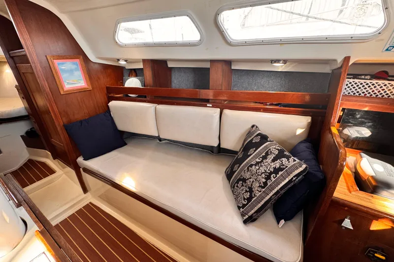 Slide: The Image of 1979 O'Day 37 Center Cockpit interior with cozy seating and decorative pillows. - 4