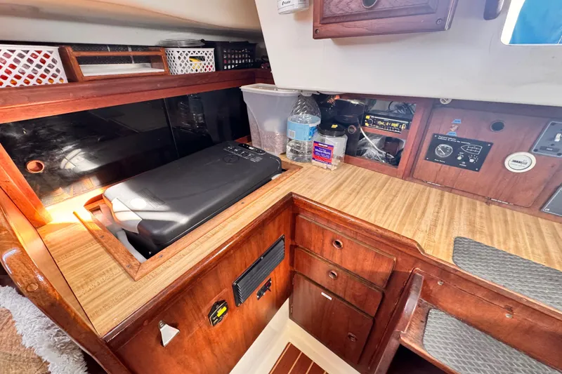 Slide: The Image of 1979 O'Day 37 Center Cockpit interior with wooden cabinetry and navigation equipment. - 7