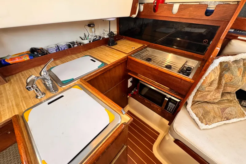 Slide: The Image of 1979 O'Day 37 Center Cockpit galley with sink, stove, and microwave. - 9