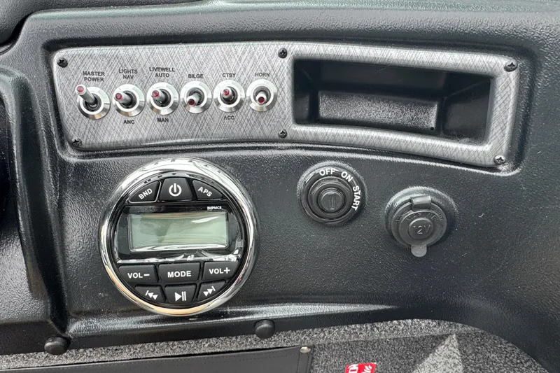 Slide: The Image of Control panel of 2026 Lund 2075 Fisherman boat with switches and audio controls. - 8