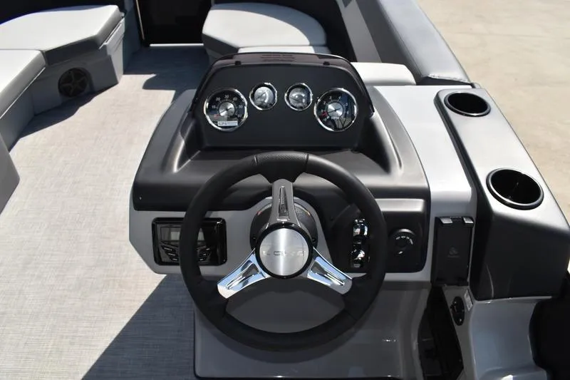 Slide: The Image of 2026 Lowe LS 170 boat interior with gray seating and a black table featuring cup holders. - 35