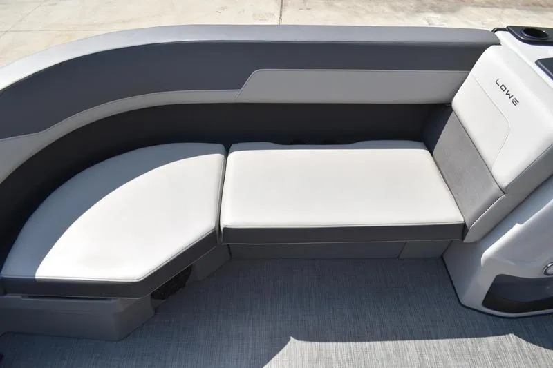 Slide: The Image of 2026 Lowe LS 170 pontoon boat on trailer, sleek design, reflective windows. - 6