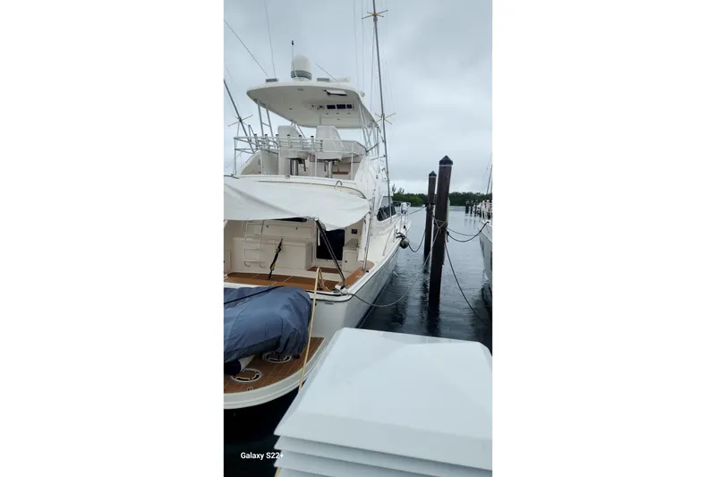 Slide: The Image of 2006 Riviera 47 Open Flybridge Series II yacht docked on a cloudy day. - 13