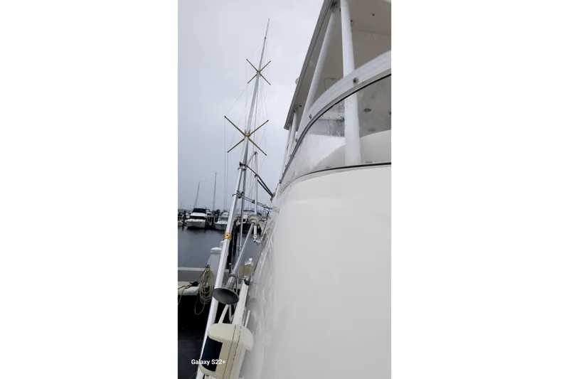 Slide: The Image of 2006 Riviera 47 Open Flybridge Series II yacht docked on a cloudy day. - 19