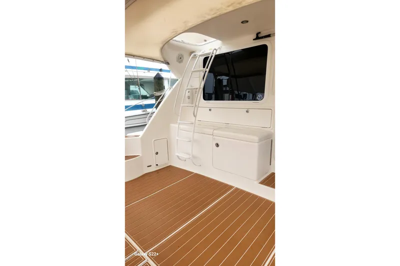 Slide: The Image of 2006 Riviera 47 Open Flybridge Series II yacht interior with ladder and wooden deck. - 27