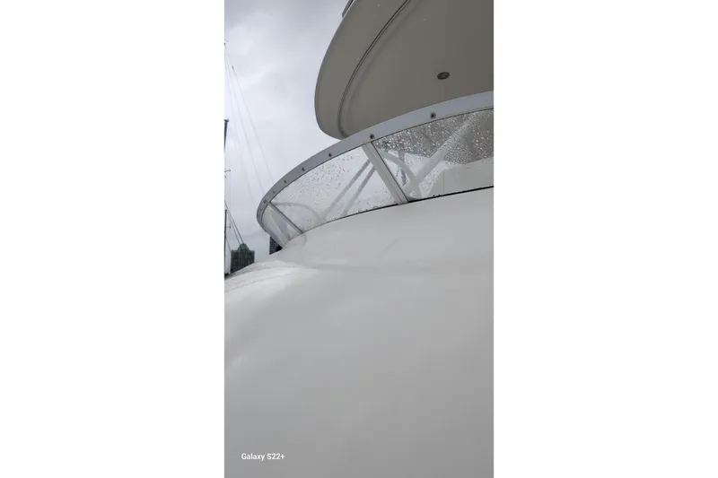 Slide: The Image of 2006 Riviera 47 Open Flybridge Series II yacht, close-up view with raindrops on glass. - 30