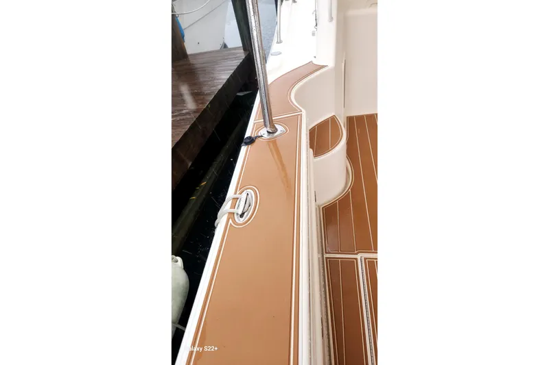 Slide: The Image of 2006 Riviera 47 Open Flybridge Series II deck with polished wood finish. - 31