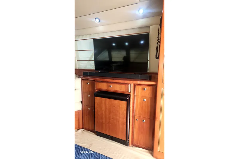 Slide: The Image of Interior of 2006 Riviera 47 Open Flybridge Series II with TV and wooden cabinetry. - 37