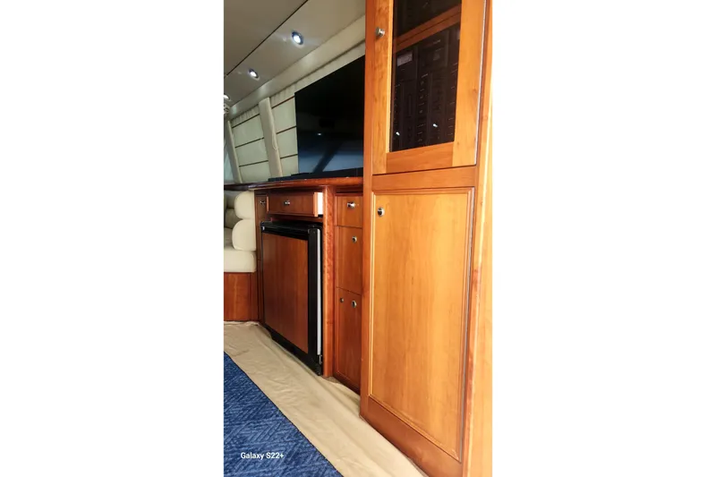 Slide: The Image of Interior of 2006 Riviera 47 Open Flybridge Series II with wooden cabinetry and seating. - 42