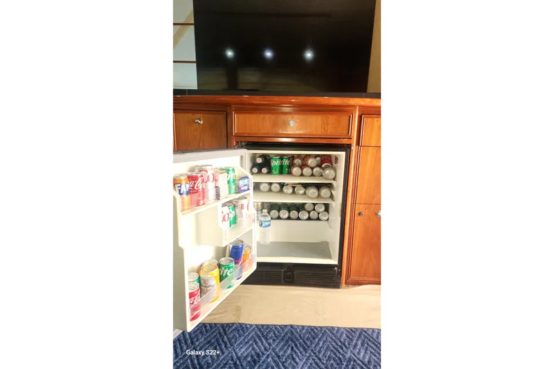 Slide: The Image of Mini fridge stocked with beverages inside a 2006 Riviera 47 Open Flybridge Series II yacht. - 48