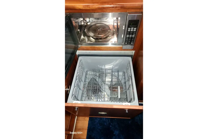 Slide: The Image of Microwave and dishwasher in 2006 Riviera 47 Open Flybridge Series II yacht kitchen. - 50