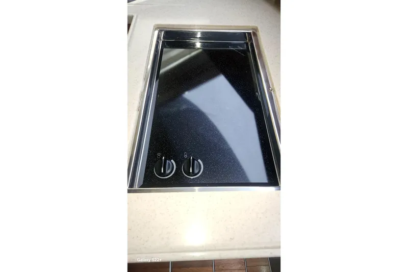 Slide: The Image of Stovetop on 2006 Riviera 47 Open Flybridge Series II yacht, featuring dual control knobs. - 56