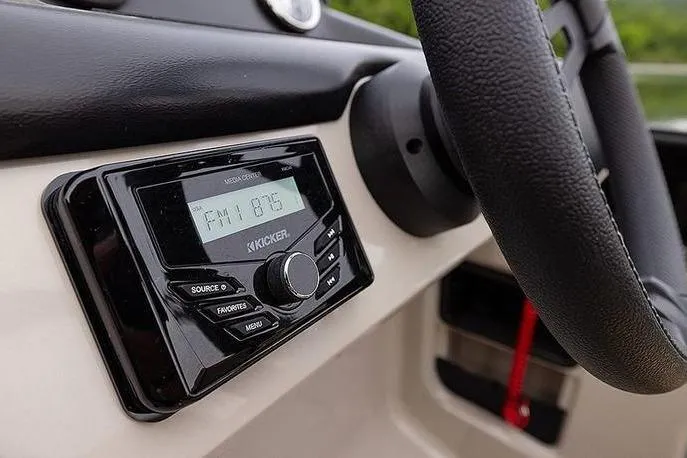 Slide: The Image of Dashboard of a 2026 Lowe LS 170 boat featuring a Kicker media stereo system. - 6