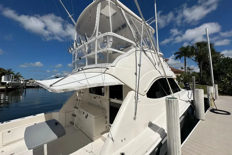 Slide: The Image of 2002 Riviera 40 Flybridge yacht docked under clear blue sky. - 10