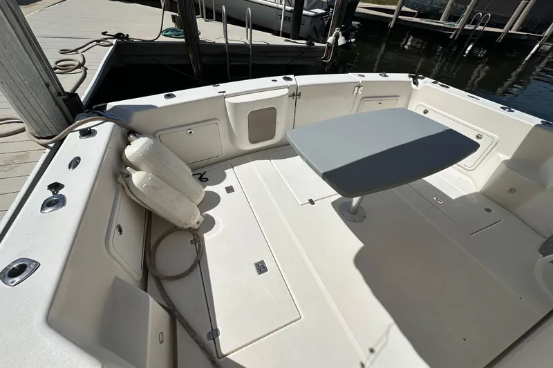 Slide: The Image of 2002 Riviera 40 Flybridge boat deck with table and docked at marina. - 11