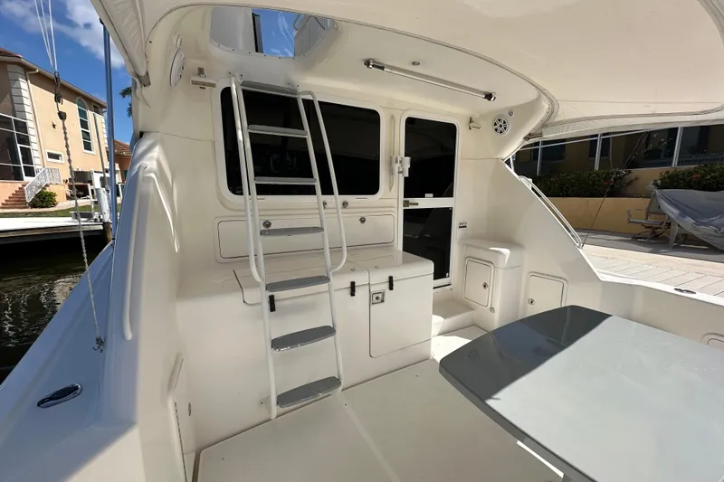 Slide: The Image of 2002 Riviera 40 Flybridge yacht interior with ladder and seating area. - 15