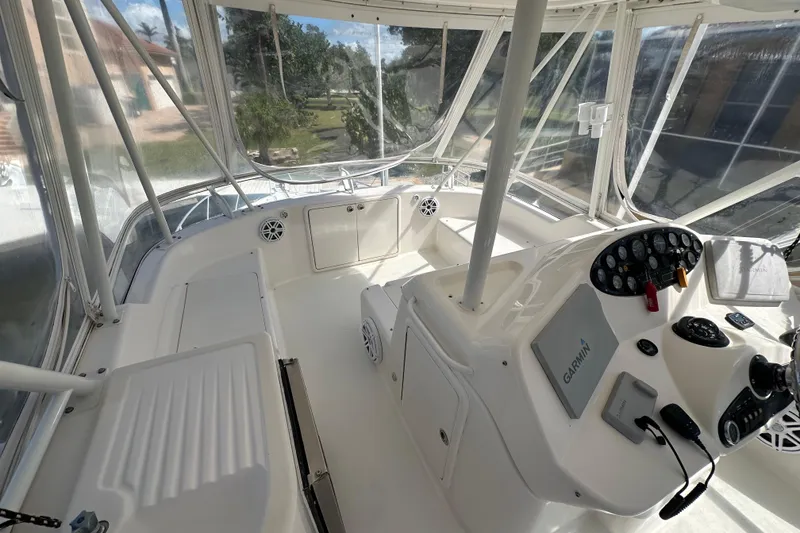 Slide: The Image of 2002 Riviera 40 Flybridge helm with Garmin navigation, enclosed by clear panels. - 22