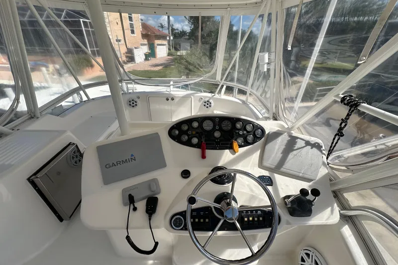 Slide: The Image of Cockpit of 2002 Riviera 40 Flybridge with Garmin navigation system and steering wheel. - 23