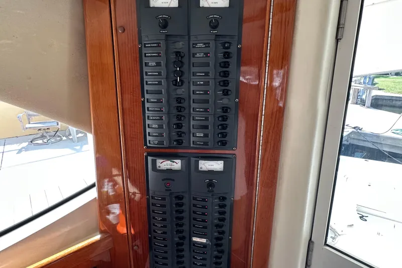 Slide: The Image of Electrical panel on a 2002 Riviera 40 Flybridge yacht, featuring switches and meters. - 25