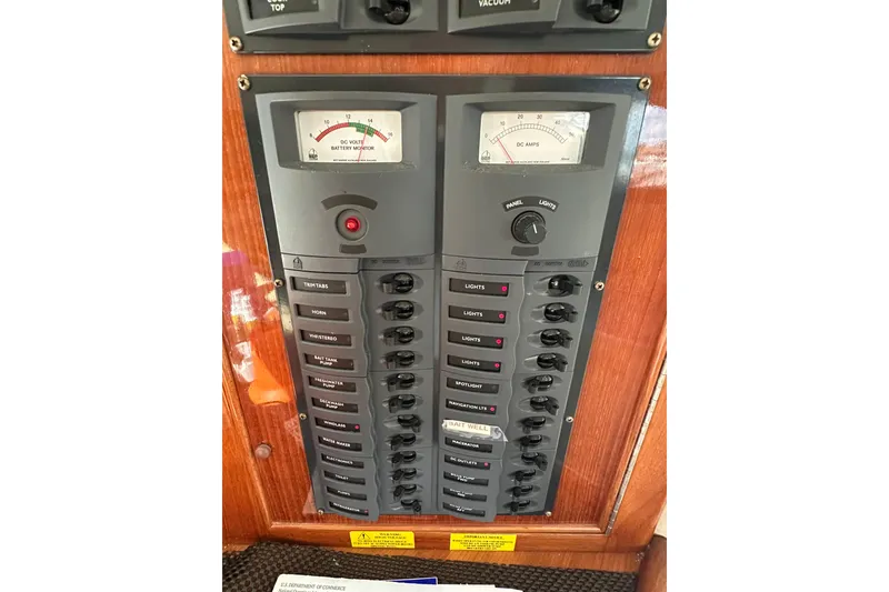 Slide: The Image of Electrical control panel on a 2002 Riviera 40 Flybridge boat, featuring switches and gauges. - 27