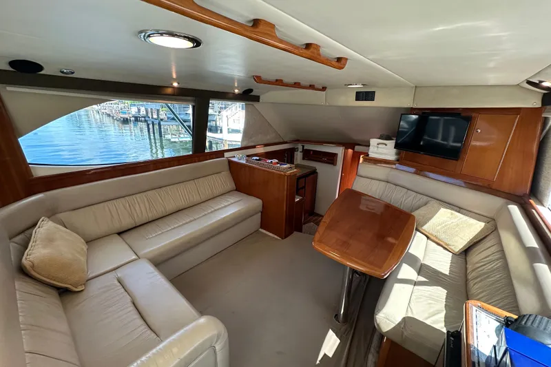 Slide: The Image of Luxurious interior of 2002 Riviera 40 Flybridge yacht with plush seating and wooden accents. - 29