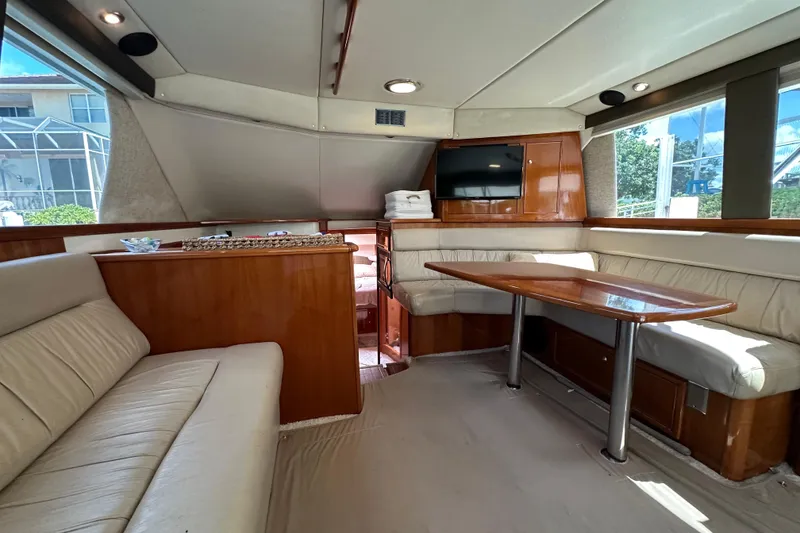 Slide: The Image of Luxurious interior of 2002 Riviera 40 Flybridge yacht with elegant seating and dining area. - 31