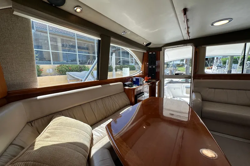 Slide: The Image of Interior of 2002 Riviera 40 Flybridge yacht with plush seating and wooden table. - 33