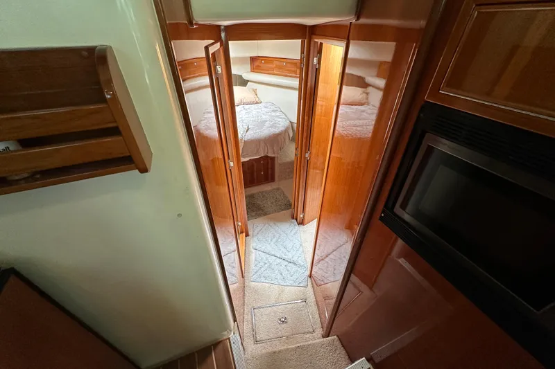 Slide: The Image of Interior of 2002 Riviera 40 Flybridge yacht with cozy cabin and wooden finishes. - 37