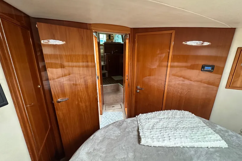 Slide: The Image of Interior of 2002 Riviera 40 Flybridge yacht with polished wood doors and cozy cabin. - 41