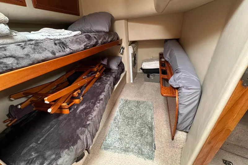 Slide: The Image of Interior cabin of 2002 Riviera 40 Flybridge with bunk beds and storage. - 44